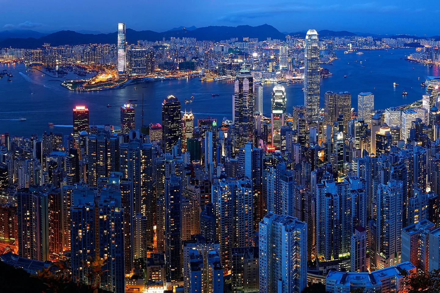 Hong Kong's illuminated skyline and Victoria Harbour at dusk, viewed from Victoria Peak.
